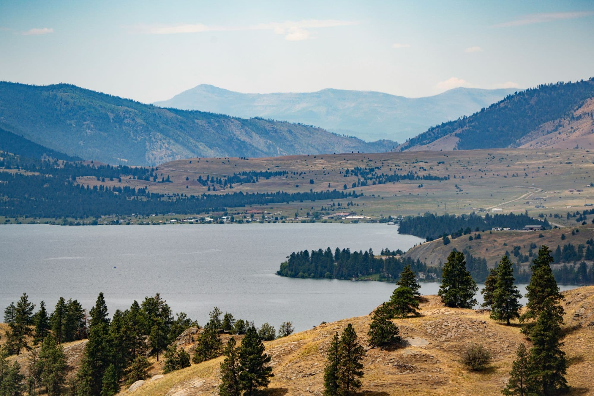 Flathead Lake shoreline with pine-covered hills and mountains in Northwest Montana